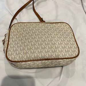 Michael Kors crossbody bag with initials MK all over it good condition